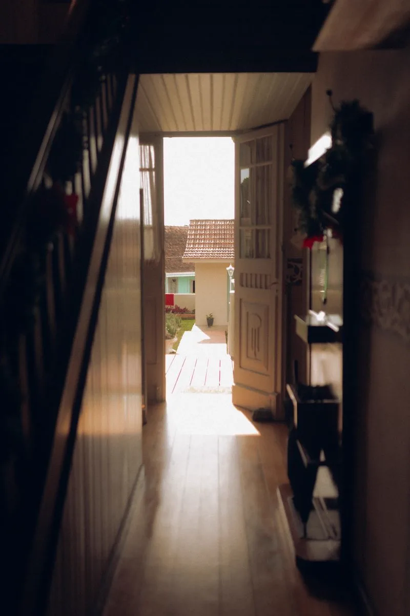 The open door of a warm, welcoming home — stable housing as the foundation of recovery